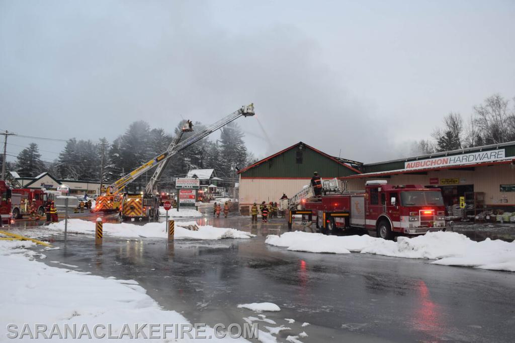 Firefighters from around 12 departments in Franklin, Essex and Clinton counties battled a massive fire at the Consolidated Electrical Distributors-Twin Electric Supply and ADK Solar building next to Aubuchon Hardware in Saranac Lake on Wednesday morning. The two cats who live in Aubuchon Hardware were saved from the fire. (Enterprise photo — Aaron Marbone)