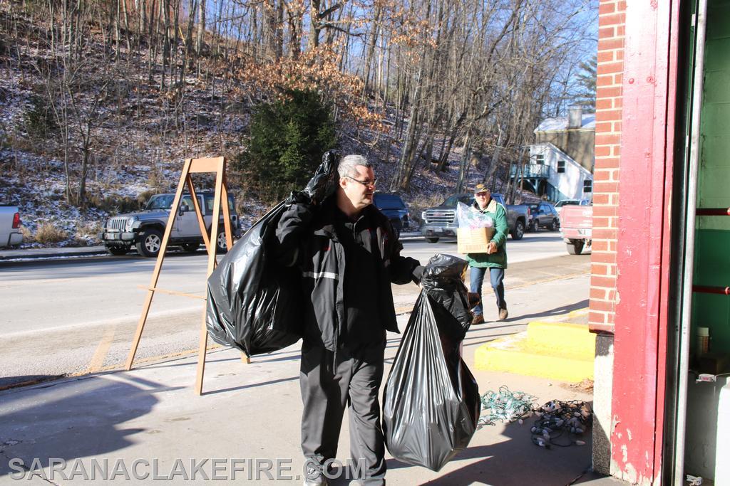 Saranac Lake Volunteer Rescue Squad Assistant Chief Jerry Stewart delivers toys...