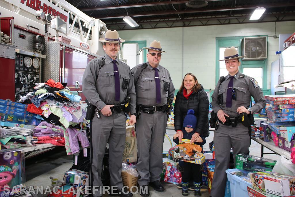 Members of the New York State Police, stop by to drop off carloads of toys.