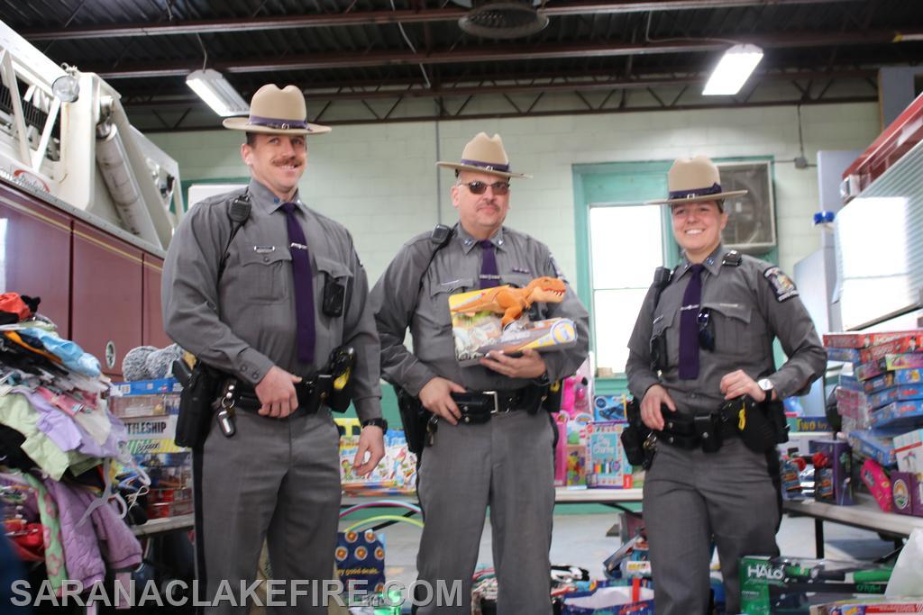 Members of the New York State Police, stop by to drop off carloads of toys.