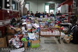 At the end of the event, SLVFD members and Holiday Helpers representatives take time to pose with the impressive pile of presents.