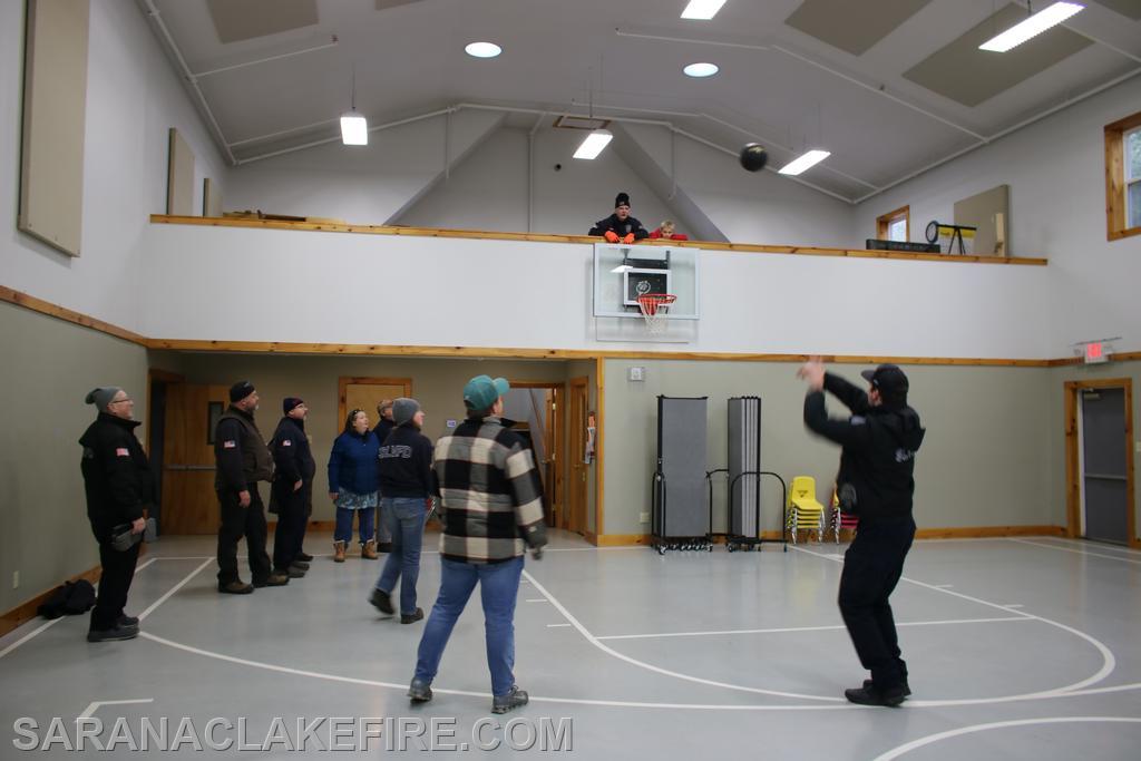 With the toys being safely delivered, SLVFD members and Holiday Helpers take some time to rest and visit at the SL Baptist church gymnasium, even a friendly game of hoops ensued.